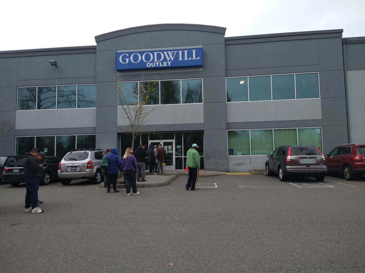 Everett Outlet Goodwill in Everett, Washington, showing blue rolling bins filled with discounted merchandise.