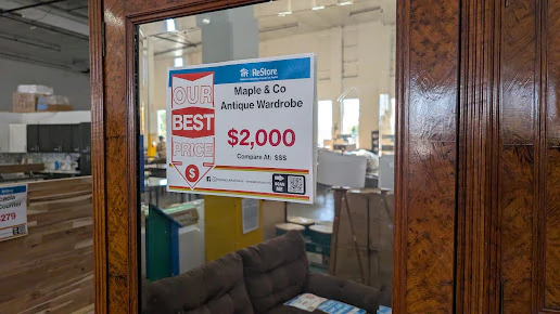 Goodwill Auction & Outlet Store in Long Beach, California, displaying a large open layout with rows of donation bins.
