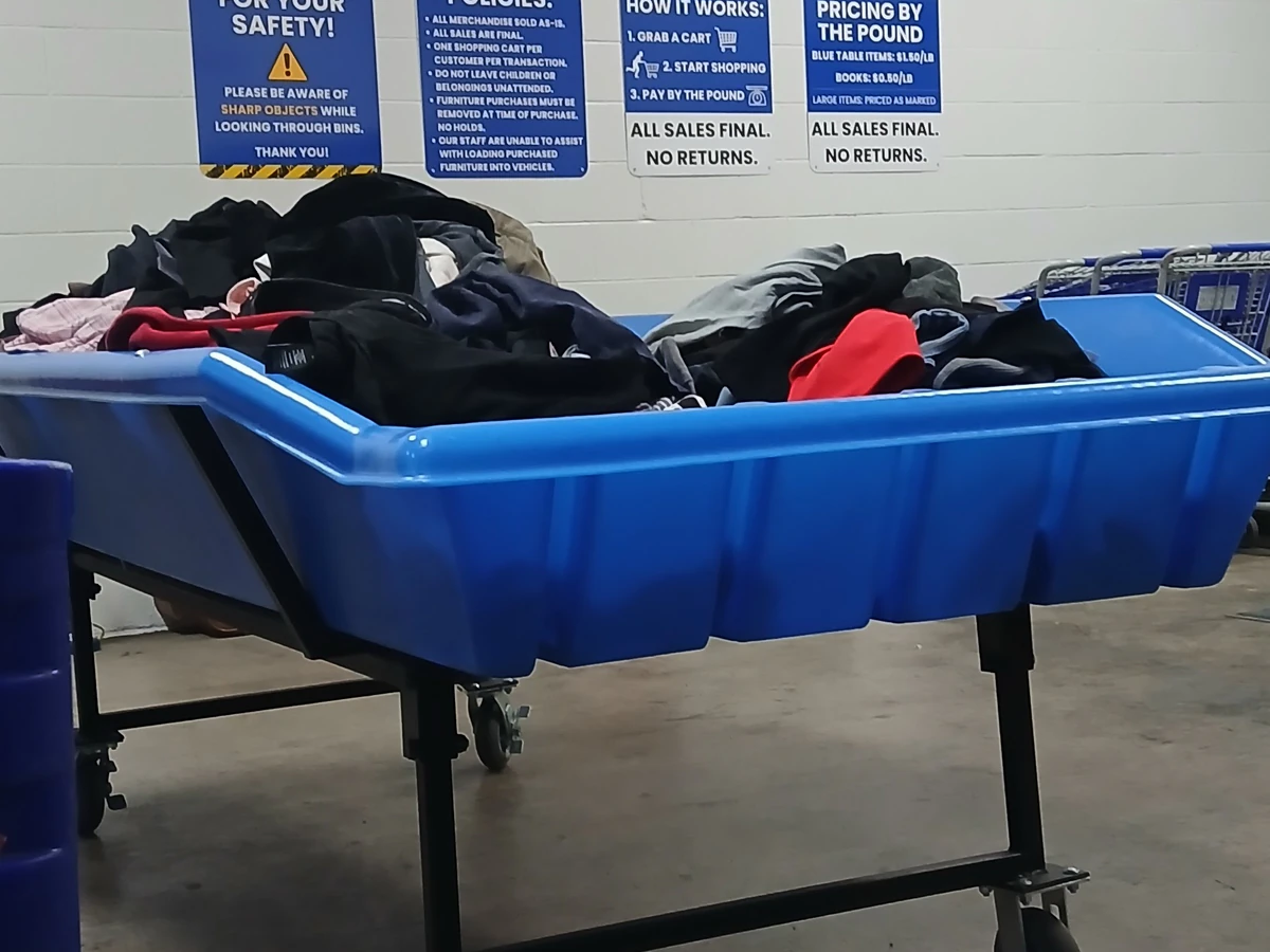 Goodwill Bellevue Industrial Plant in Bellevue, Ohio, showing rows of affordable footwear and accessories for sale.