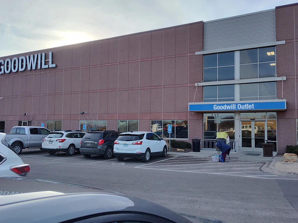 Goodwill - Brooklyn Park Outlet in Brooklyn Park, Minnesota, showing blue rolling bins filled with discounted merchandise.