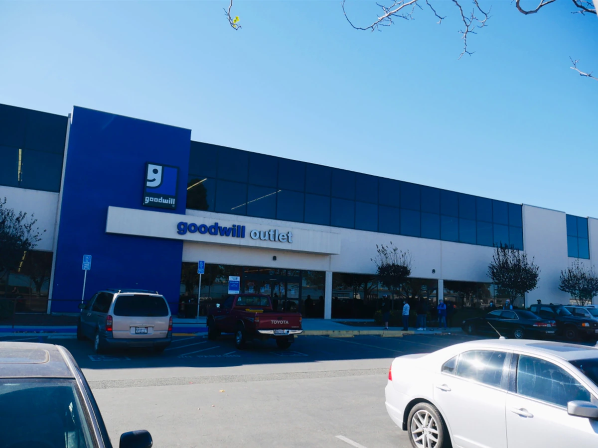 Goodwill Central Coast Outlet in Salinas, California, showing blue rolling bins filled with discounted merchandise.