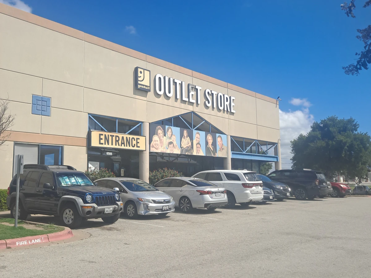 Goodwill Central Texas - Outlet South in Austin, Texas, showing blue rolling bins filled with discounted merchandise.