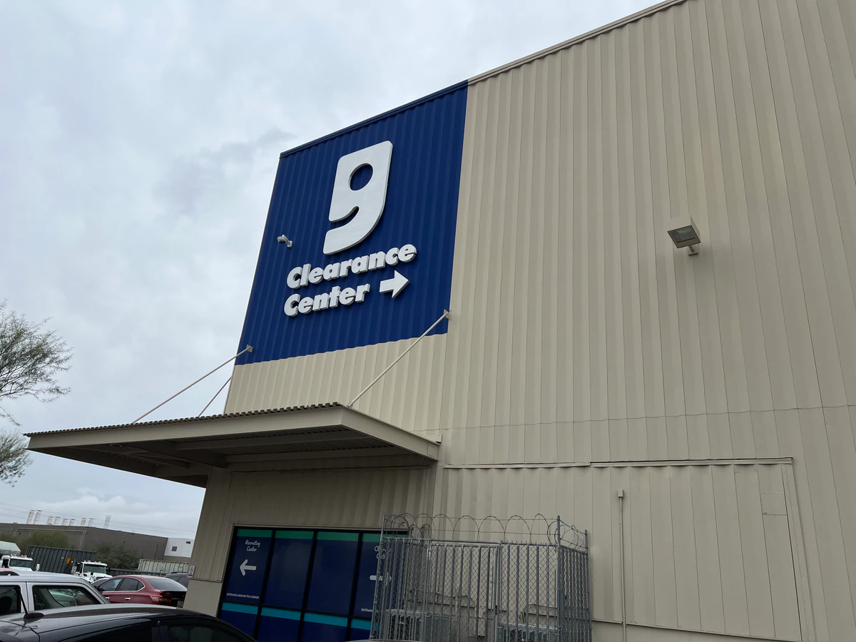 Goodwill Clearance Center in Phoenix, Arizona, showing neatly organized clothing racks and household goods.
