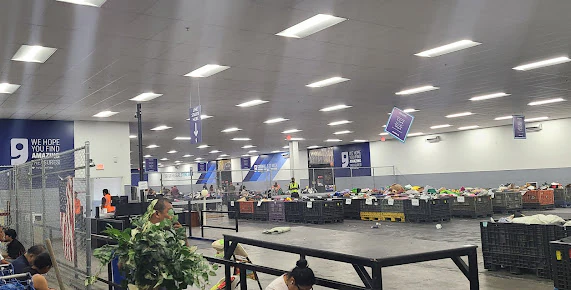 Goodwill Clearance Center in Phoenix, Arizona, showing rows of affordable footwear and accessories for sale.