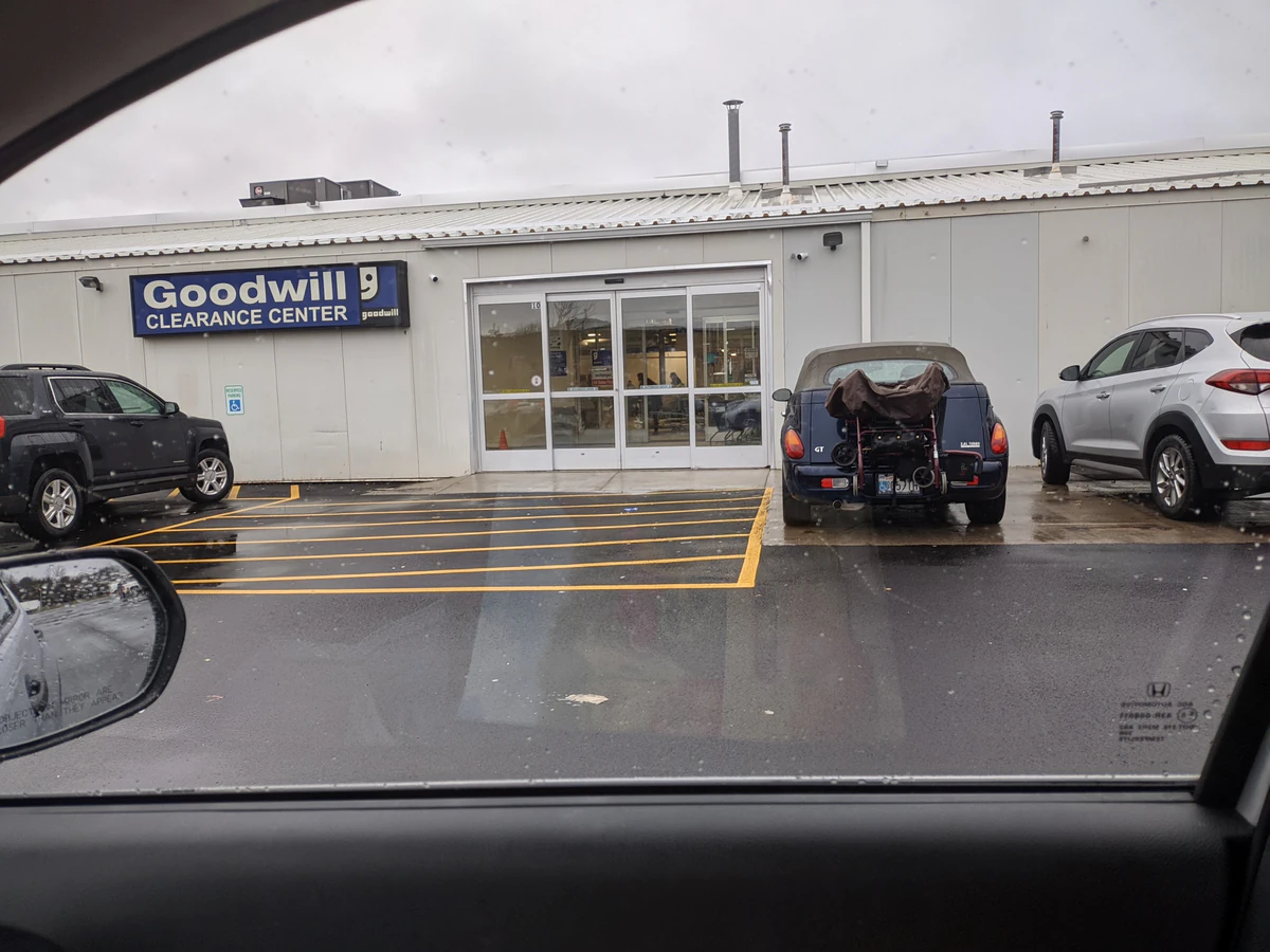 Goodwill Clearance Center in Rochester, New-york, showing neatly organized clothing racks and household goods.