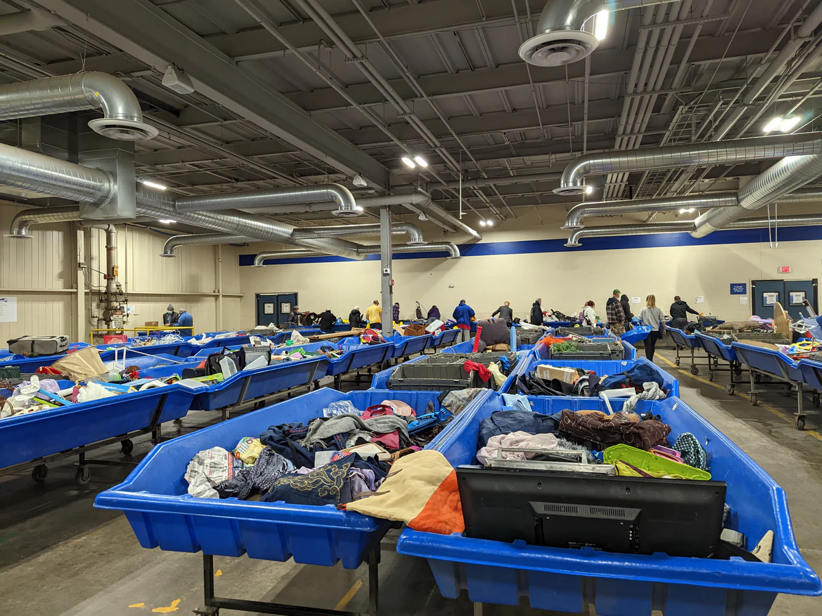 Goodwill Clearance Center in Rochester, New-york, showing rows of affordable footwear and accessories for sale.