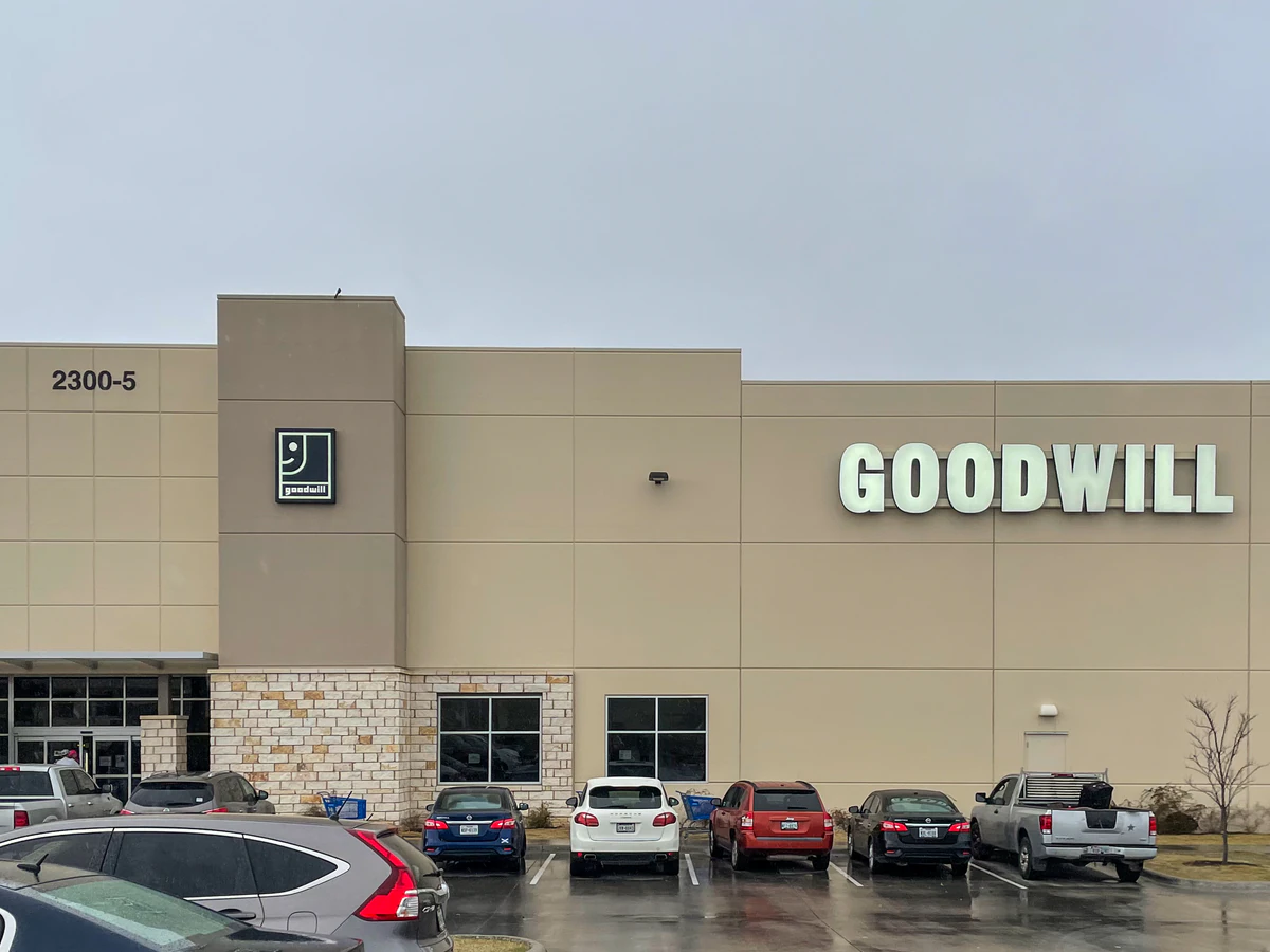 Goodwill Distribution Center - North Outlet in Austin, Texas, showing blue rolling bins filled with discounted merchandise.