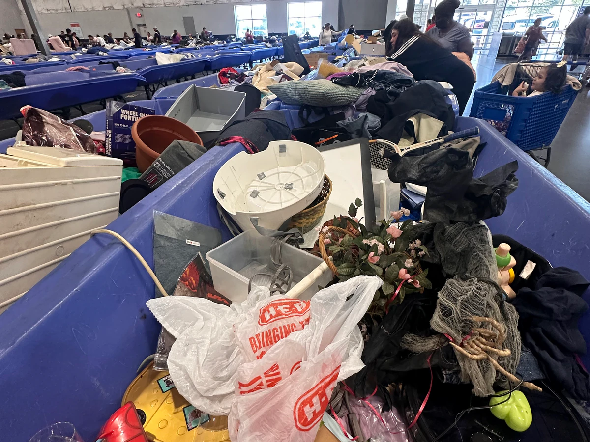 Goodwill Distribution Center - North Outlet in Austin, Texas, featuring shoppers searching through bulk textile containers.
