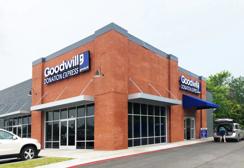 Goodwill Donation Express in Centerton, Arkansas, showing neatly organized clothing racks and household goods.