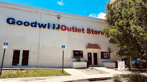 Goodwill in Fort Lauderdale, Florida, a Goodwill thrift store featuring display shelves with books and home decor items.