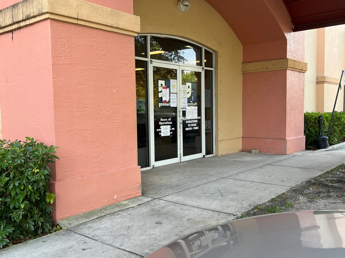 Goodwill Ft. Pierce Bargain Barn in Fort Pierce, Florida, showing blue rolling bins filled with discounted merchandise.