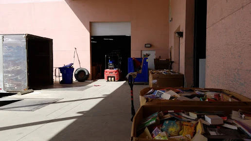 Goodwill Ft. Pierce Bargain Barn in Fort Pierce, Florida, featuring shoppers searching through bulk textile containers.