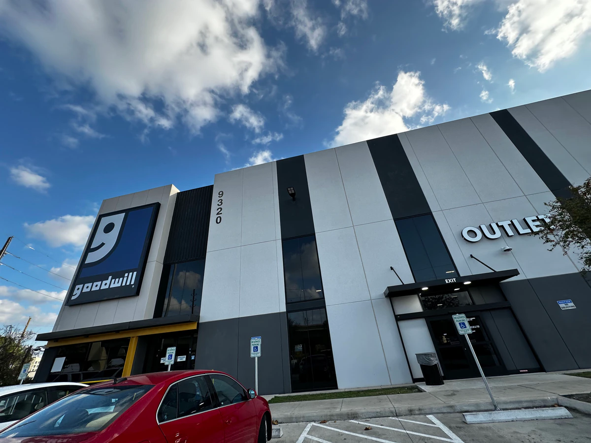 Goodwill G1 Outlet Store in Houston, Texas, showing blue rolling bins filled with discounted merchandise.