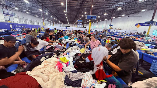Goodwill G1 Outlet Store in Houston, Texas, featuring shoppers searching through bulk textile containers.