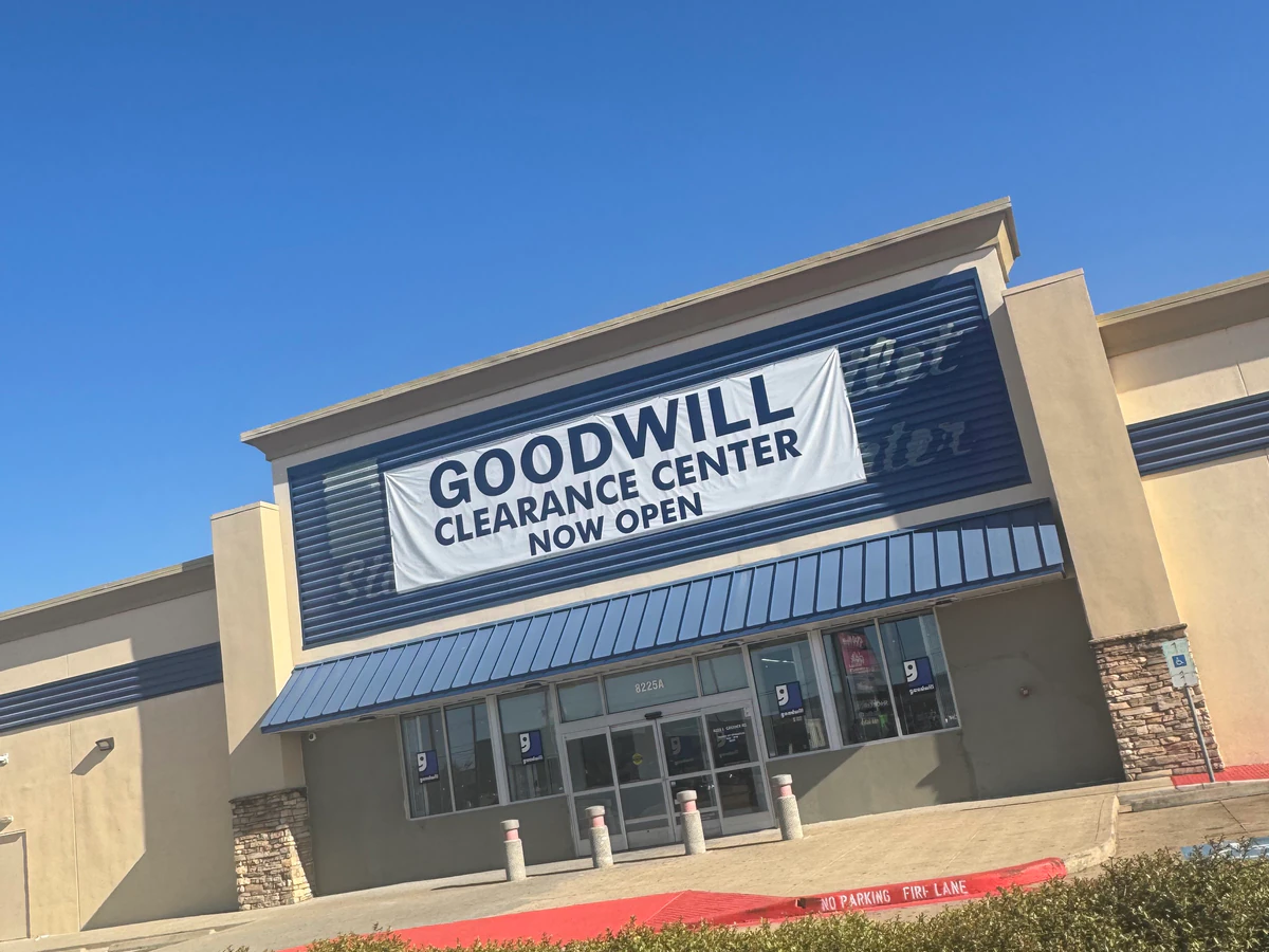 Goodwill Houston clearance center in Houston, Texas, showing neatly organized clothing racks and household goods.