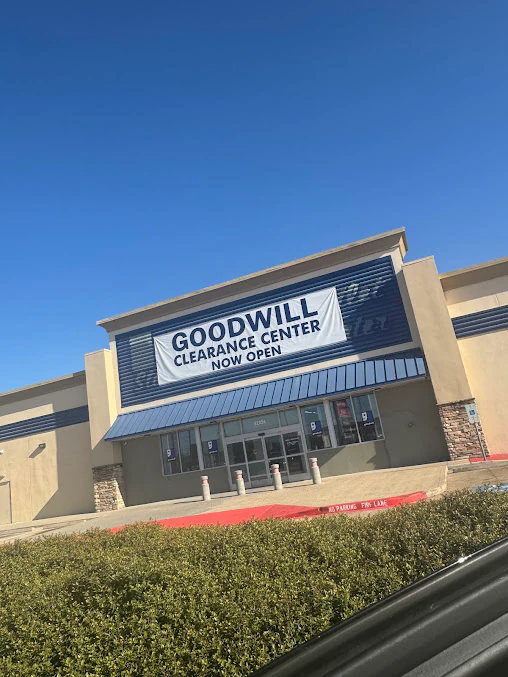 Goodwill Houston clearance center in Houston, Texas, featuring display shelves with books and home decor items.