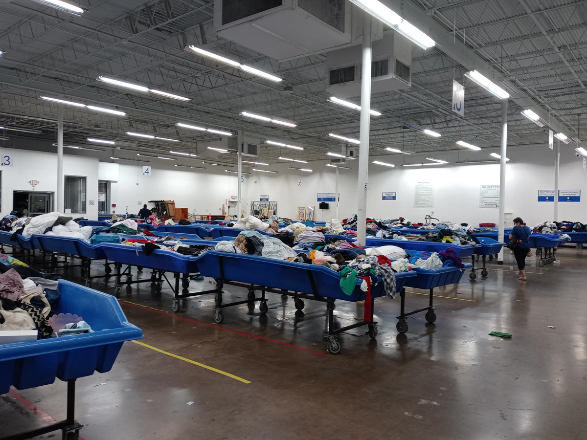 Goodwill Houston clearance center in Houston, Texas, showing rows of affordable footwear and accessories for sale.