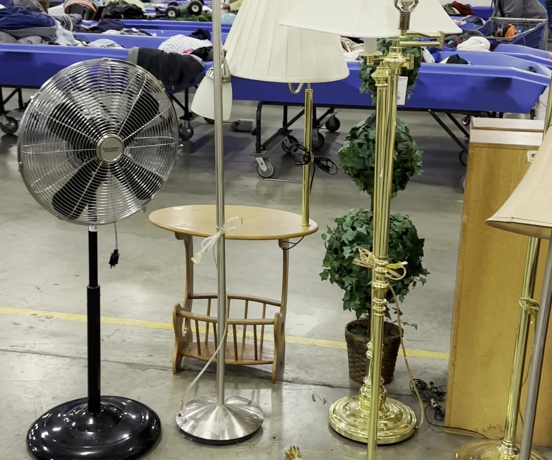 Goodwill Industries of the Columbia Willamette, a Goodwill thrift store featuring display shelves with books and home decor .