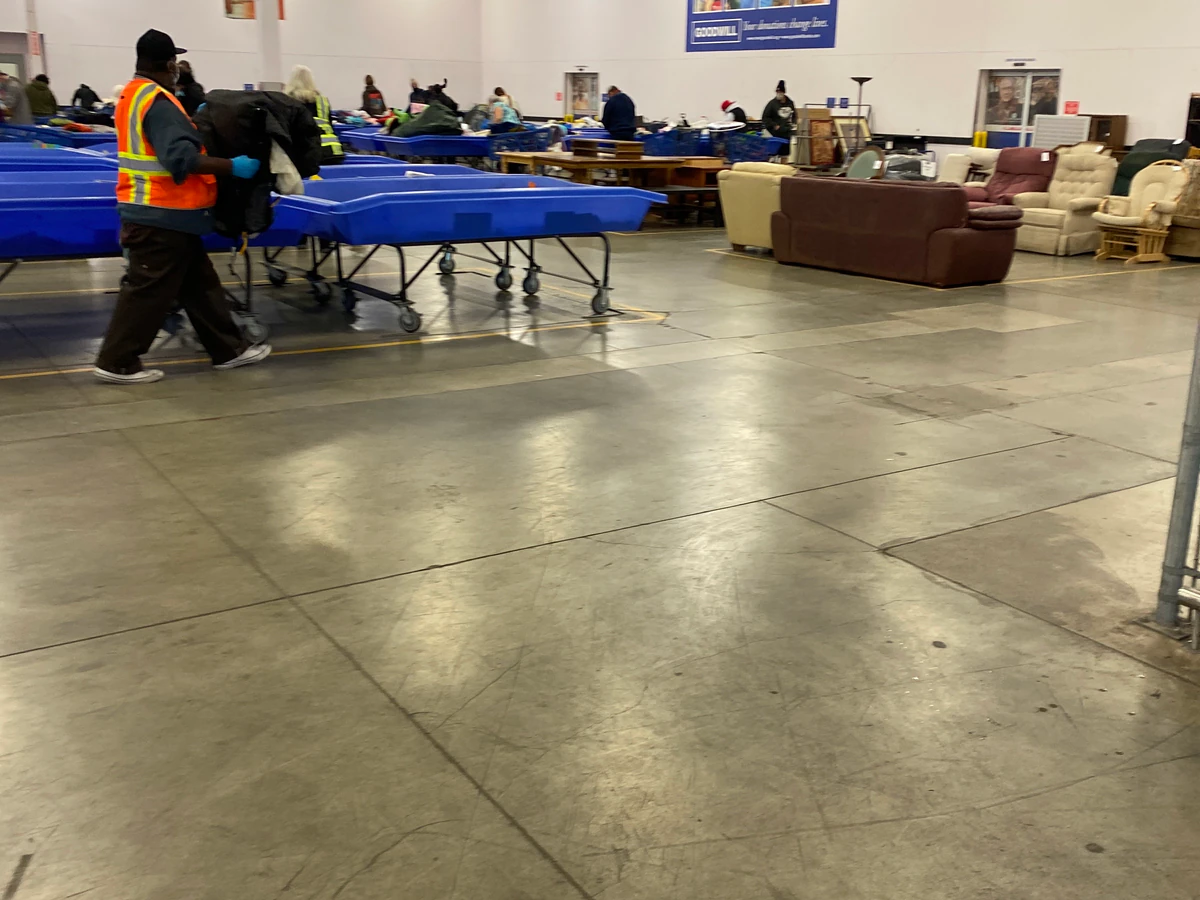 Goodwill Industries of the Columbia Willamette, a Goodwill thrift store showing rows of affordable footwear and accessories .