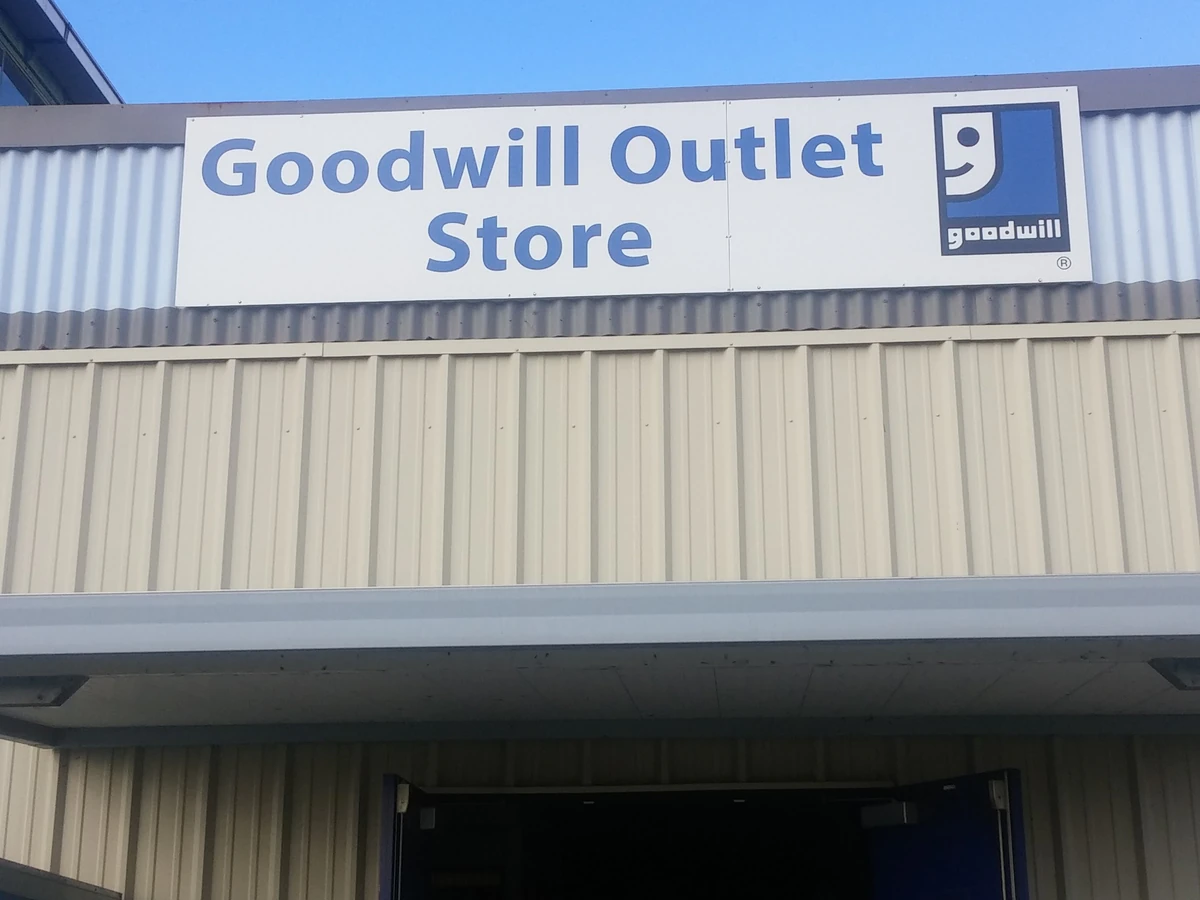 Goodwill Industries - Outlet Store in Shreveport, Louisiana, showing blue rolling bins filled with discounted merchandise.