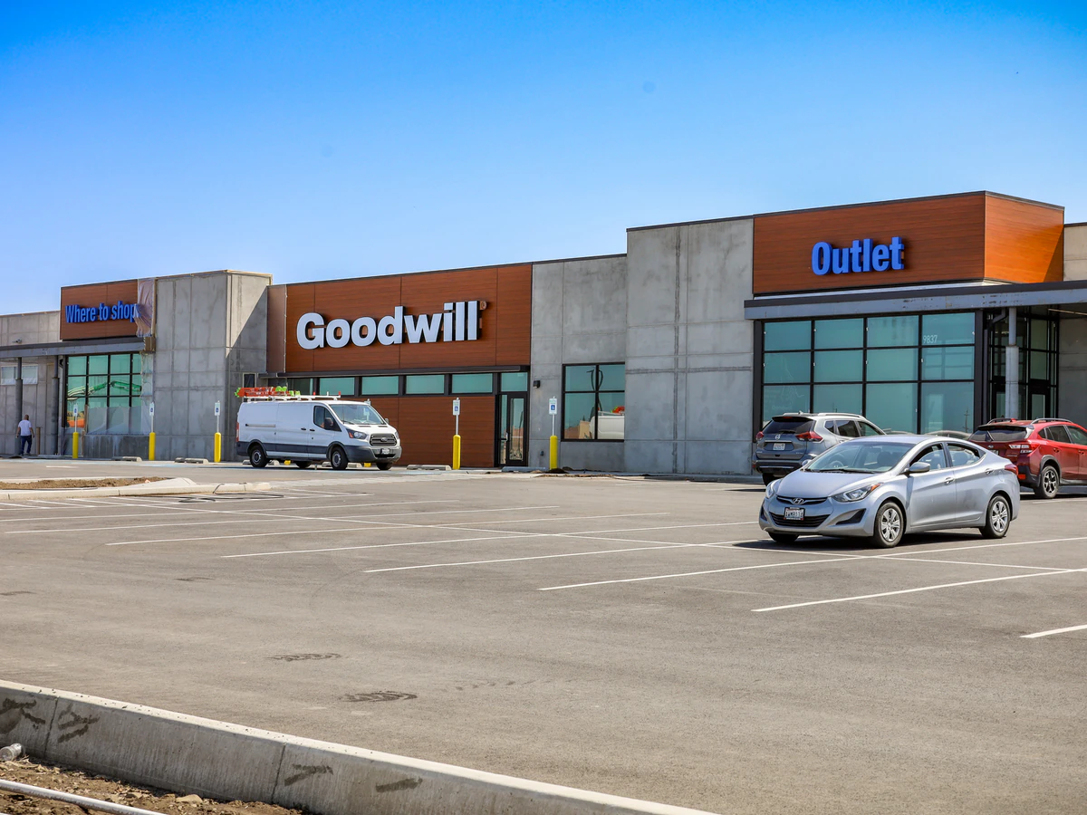 Goodwill Industries Outlet Store in Spokane, Washington, showing blue rolling bins filled with discounted merchandise.