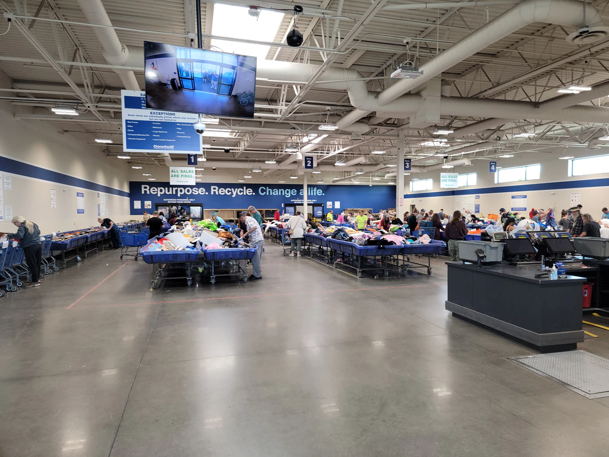 Goodwill Industries Outlet Store in Spokane, Washington, highlighting organized racks of clothing near the checkout area.