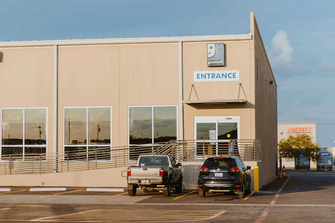 Goodwill Laredo Outlet in Laredo, Texas, showing blue rolling bins filled with discounted merchandise.
