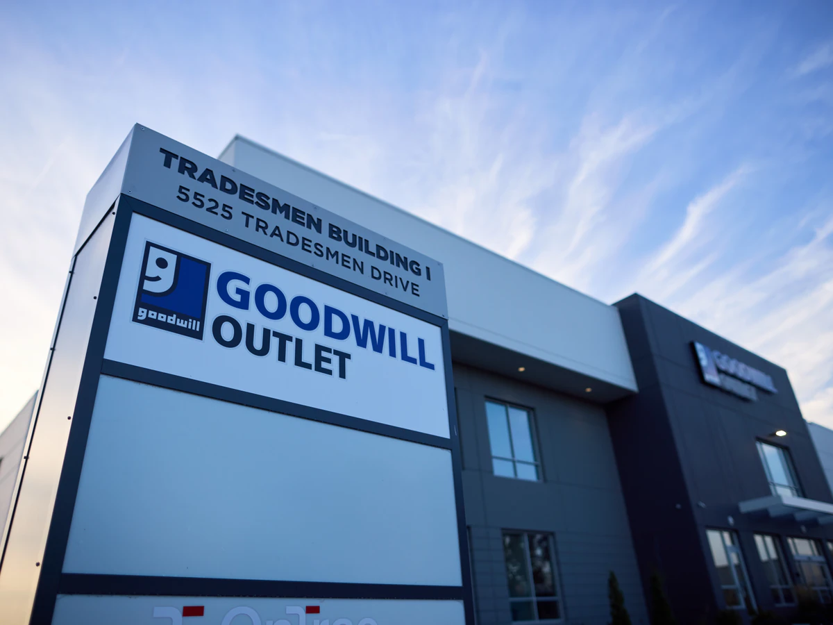 Goodwill Madison Outlet Store in Madison, Wisconsin, showing blue rolling bins filled with discounted merchandise.