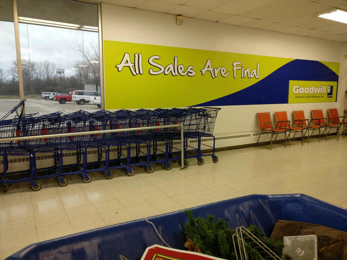 Goodwill Mid-Michigan Outlet in Flint, Michigan, showing blue rolling bins filled with discounted merchandise.