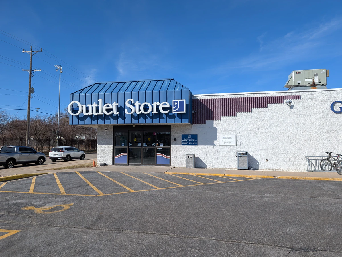 Goodwill NCW Outlet Store in Appleton, Wisconsin, showing blue rolling bins filled with discounted merchandise.