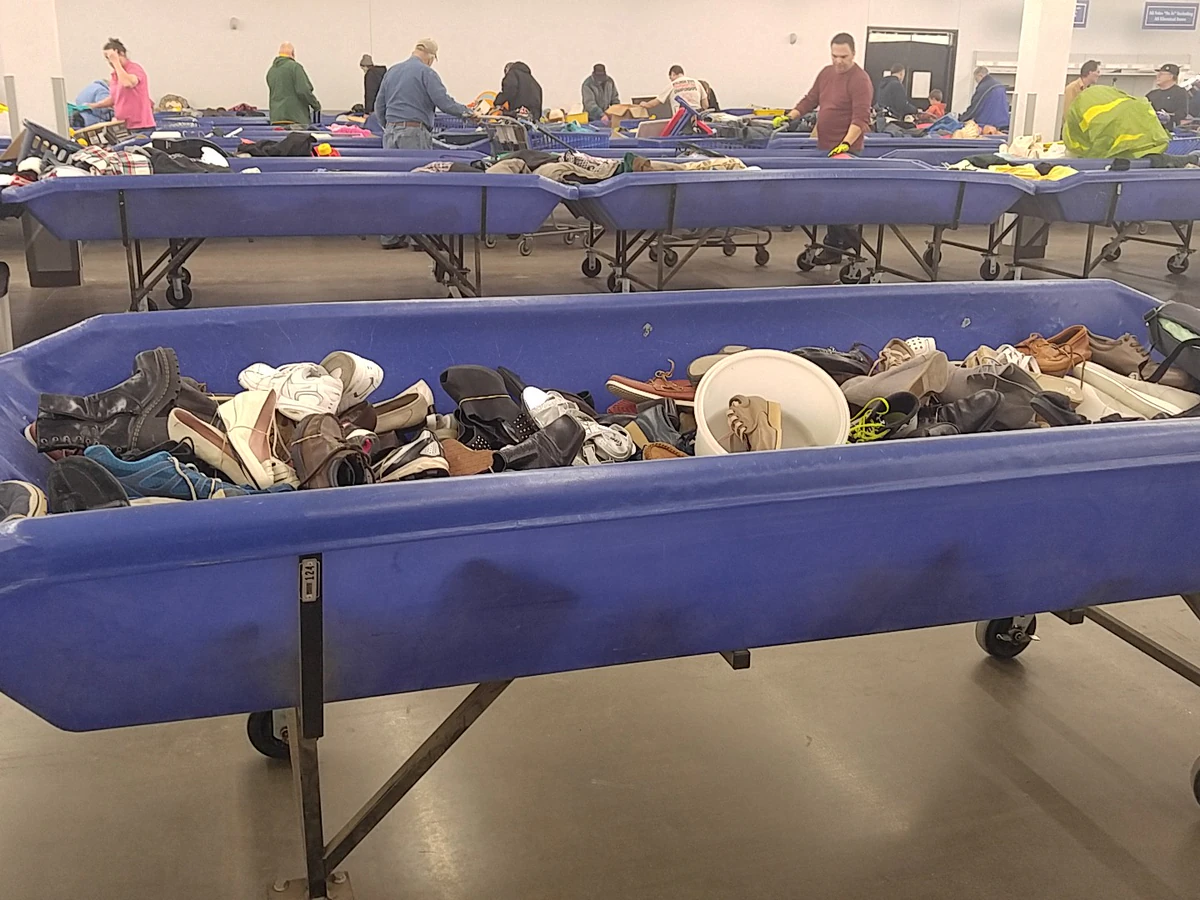 Goodwill NCW Outlet Store in Appleton, Wisconsin, featuring shoppers searching through bulk textile containers.