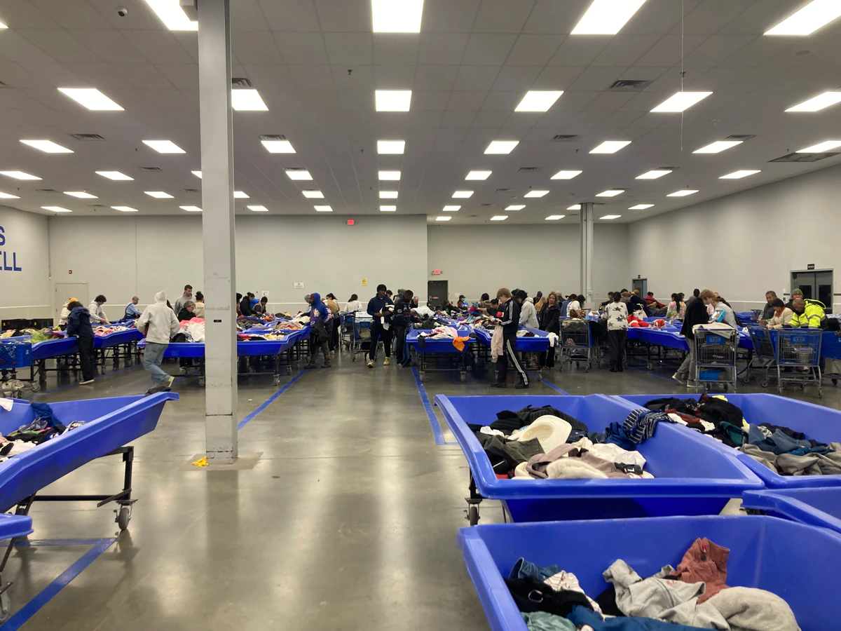 Goodwill NYNJ Outlet Store & Donation Center, a Goodwill outlet store featuring shoppers searching through bulk textile cont.