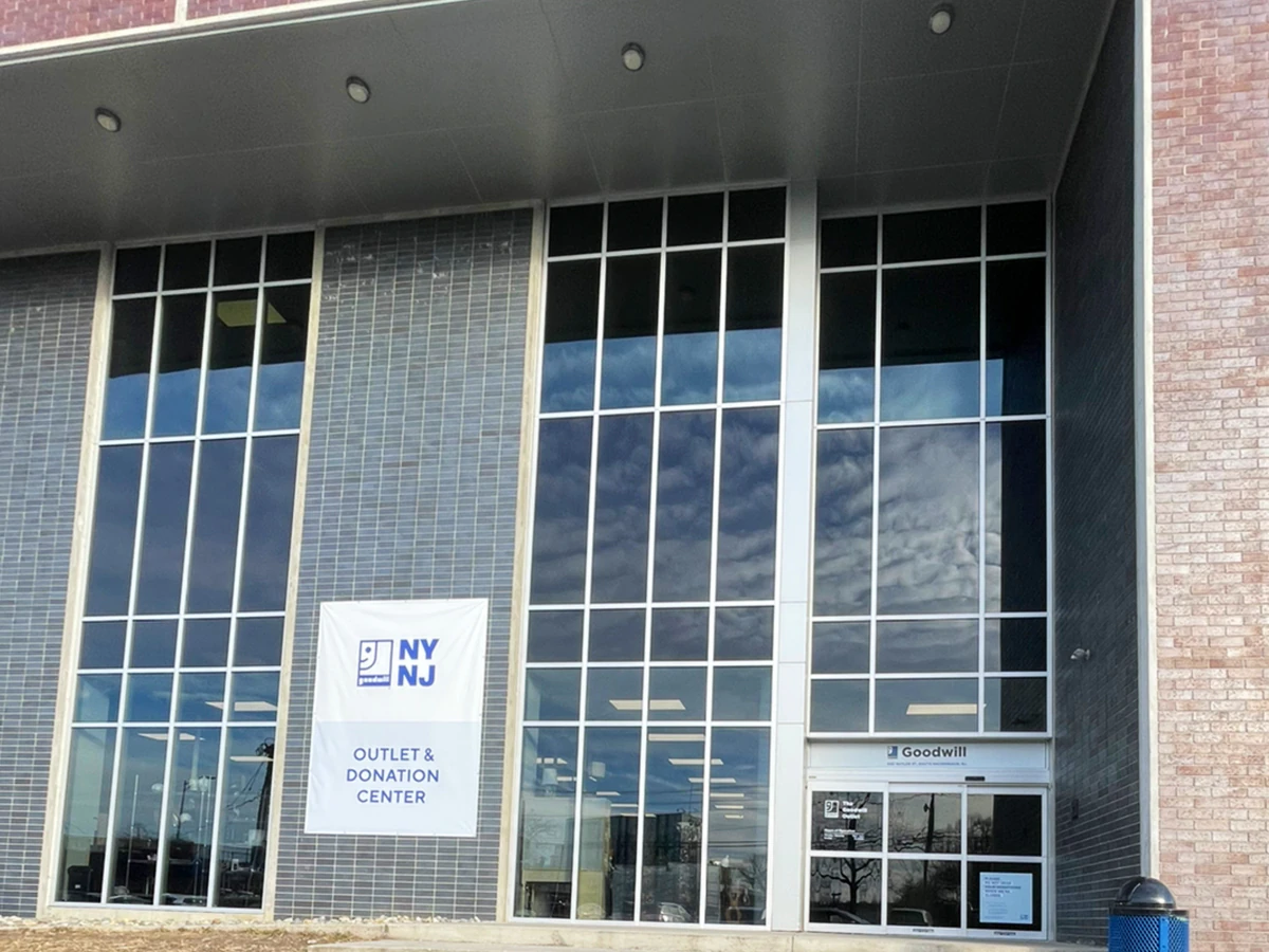 Goodwill NYNJ Outlet Store & Donation Center, a Goodwill outlet store highlighting organized racks of clothing near the chec.
