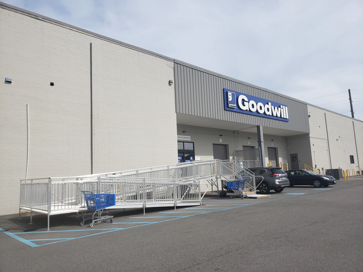 Goodwill of Central and Coastal Virginia Outlet, a Goodwill outlet store showing blue rolling bins filled with discounted me.