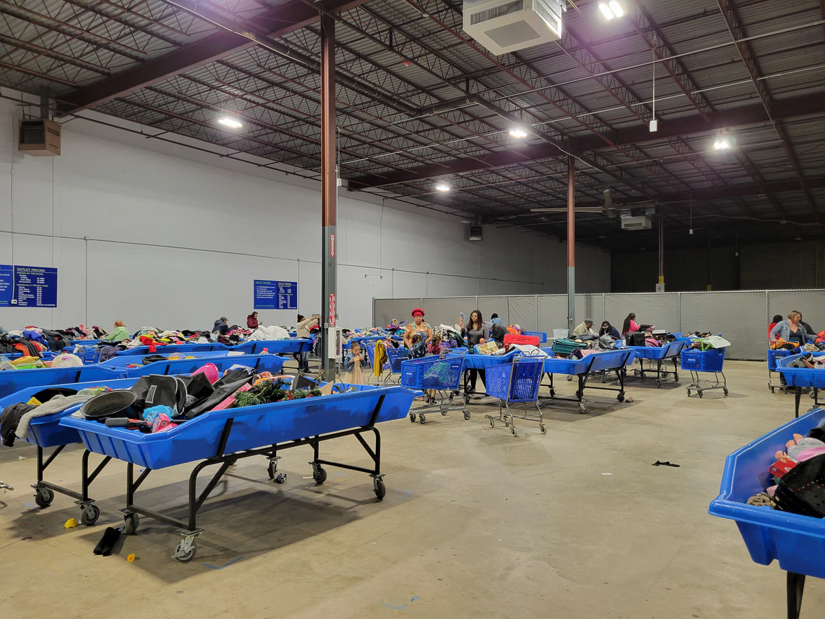 Goodwill of Central and Coastal Virginia Outlet, a Goodwill outlet store featuring shoppers searching through bulk textile c.