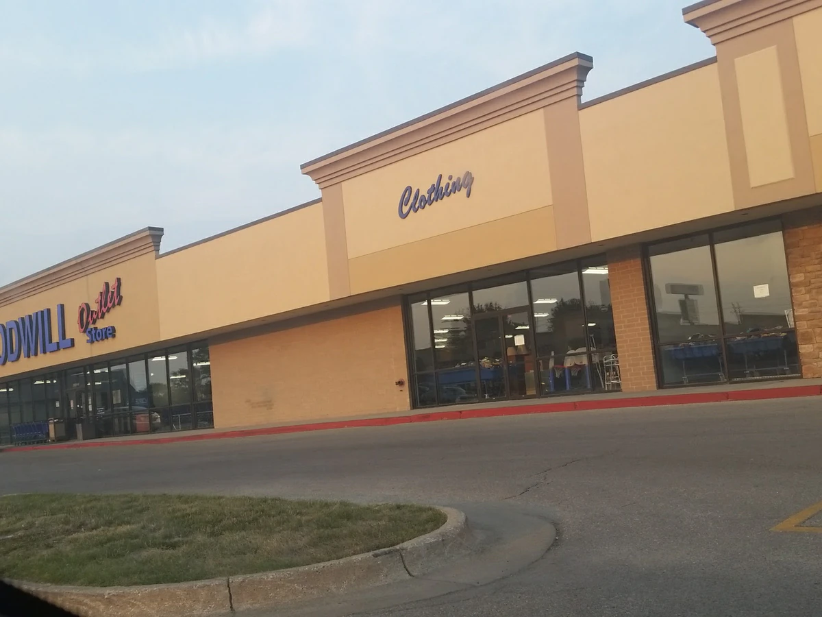 Goodwill of Central Iowa - Outlet in Des Moines, Iowa, showing blue rolling bins filled with discounted merchandise.