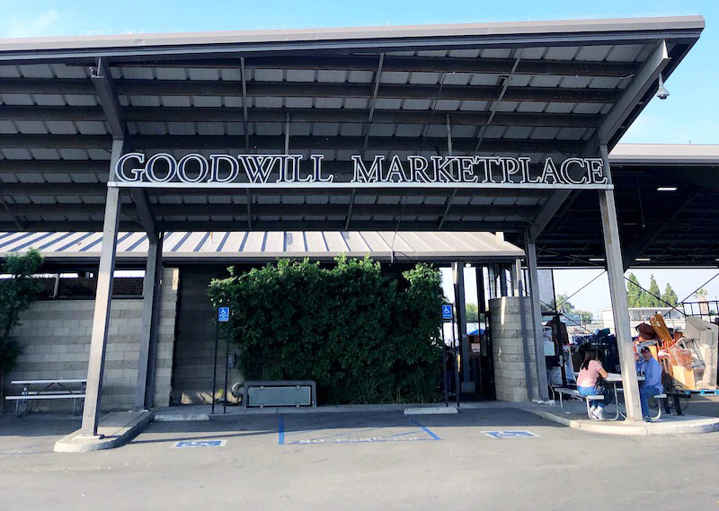 Goodwill of Orange County Marketplace in Santa Ana, California, showing neatly organized clothing racks and household goods.