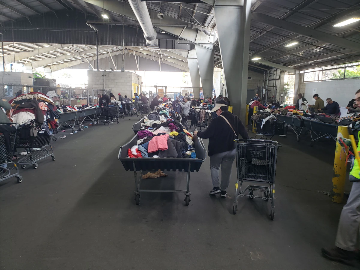 Goodwill of Orange County Marketplace in Santa Ana, California, showing rows of affordable footwear and accessories for sale.