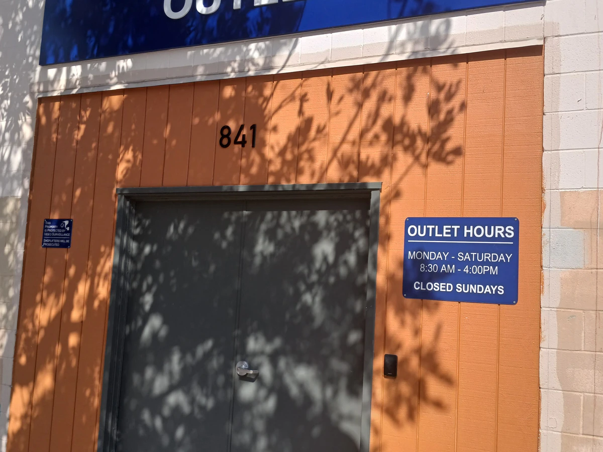 Goodwill Outlet and Donation Center in San Diego, California, showing blue rolling bins filled with discounted merchandise.
