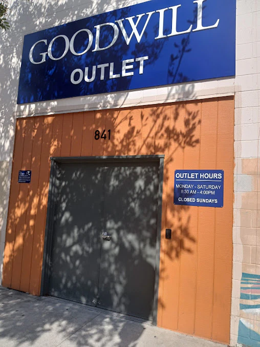 Goodwill Outlet and Donation Center in San Diego, California, displaying a large open layout with rows of donation bins.