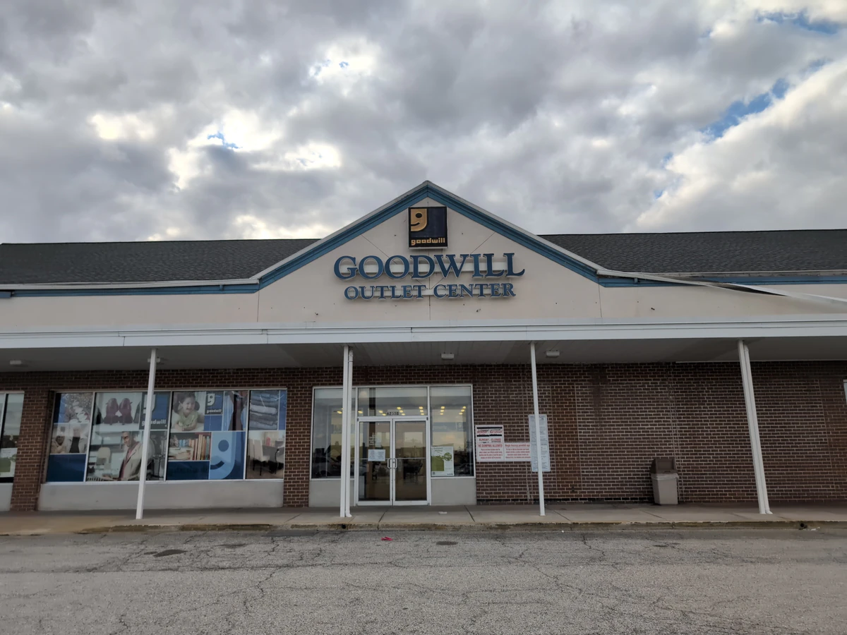 Goodwill Outlet and Donation Center in Baltimore, Maryland, showing blue rolling bins filled with discounted merchandise.