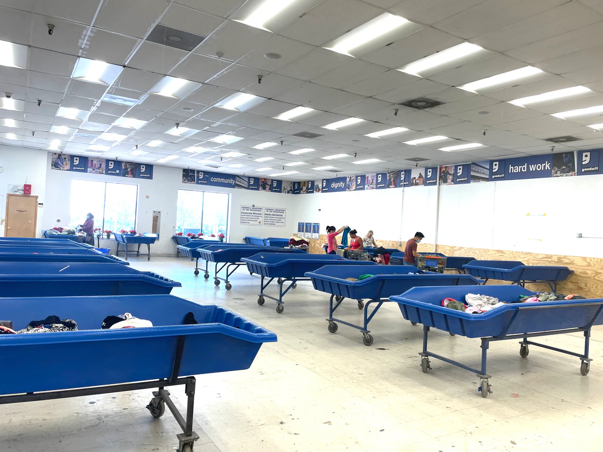 Goodwill Outlet and Donation Center in Baltimore, Maryland, highlighting organized racks of clothing near the checkout area.