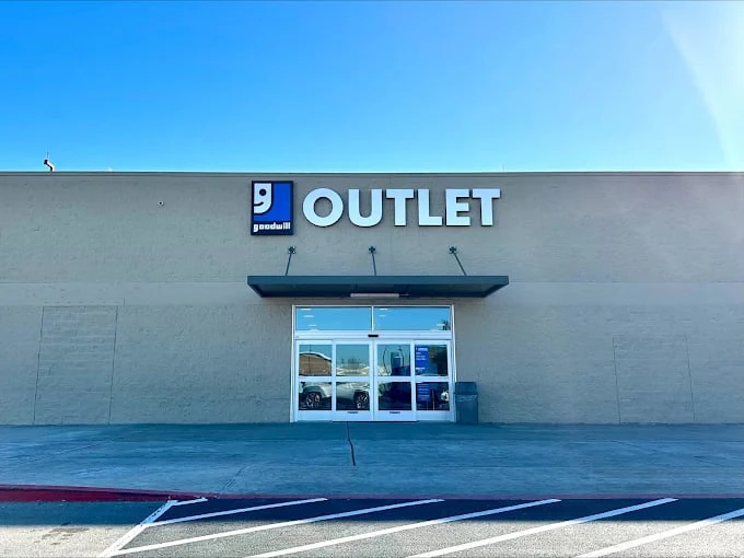 Goodwill Outlet and Donation Station in Windcrest, Texas, showing blue rolling bins filled with discounted merchandise.