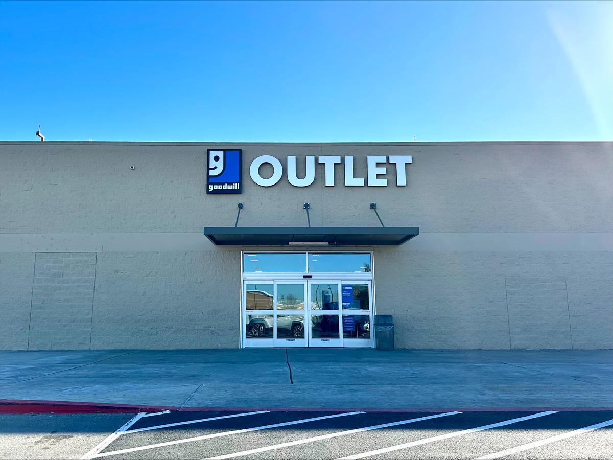Goodwill Outlet and Donation Station in Windcrest, Texas, featuring shoppers searching through bulk textile containers.