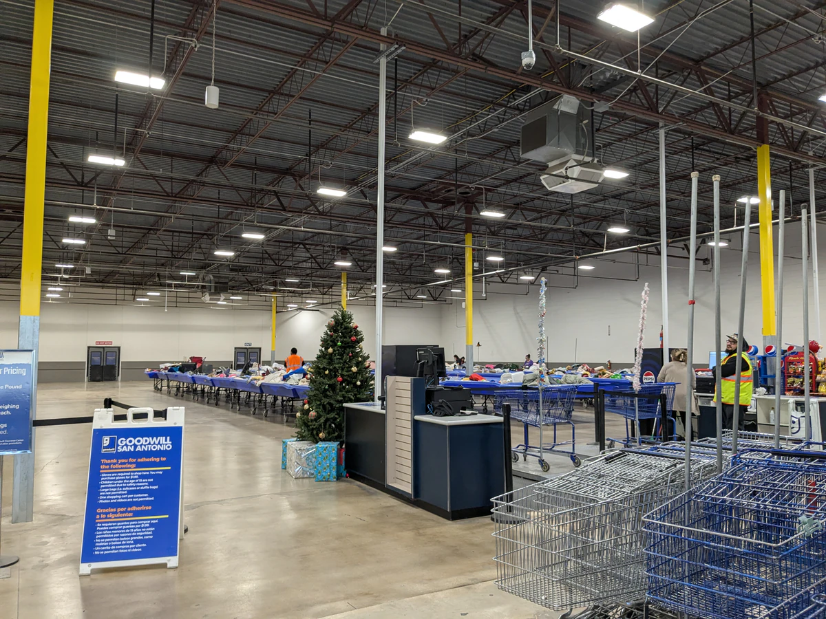 Goodwill Outlet and Donation Station in Windcrest, Texas, highlighting organized racks of clothing near the checkout area.