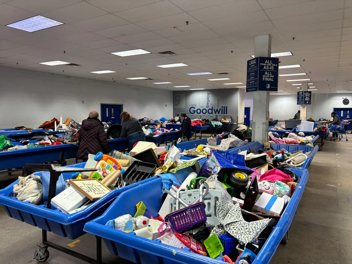 Goodwill Outlet Canton in Canton, Ohio, a Goodwill outlet store featuring shoppers searching through bulk textile containers.