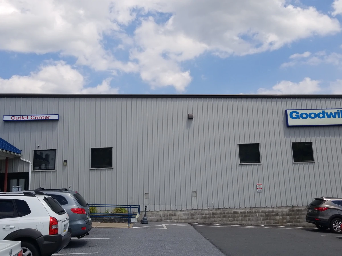 Goodwill Outlet Center & Donation Center, a Goodwill outlet store showing blue rolling bins filled with discounted merchandi.