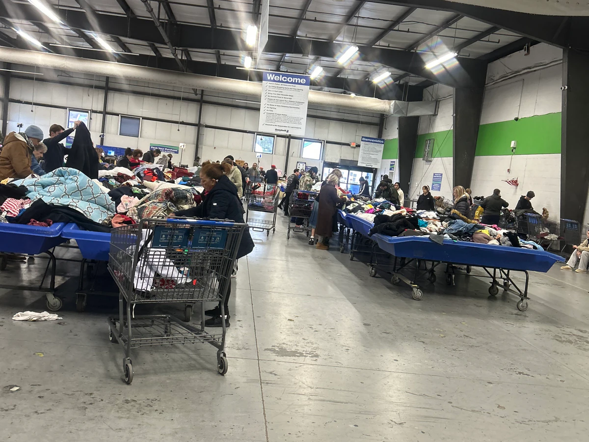 Goodwill Outlet Center & Donation Center, a Goodwill outlet store featuring shoppers searching through bulk textile containe.