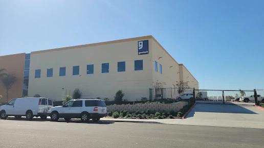 Goodwill Outlet Center, Electronics Store and Donation Center, a Goodwill outlet store highlighting organized racks of cloth.