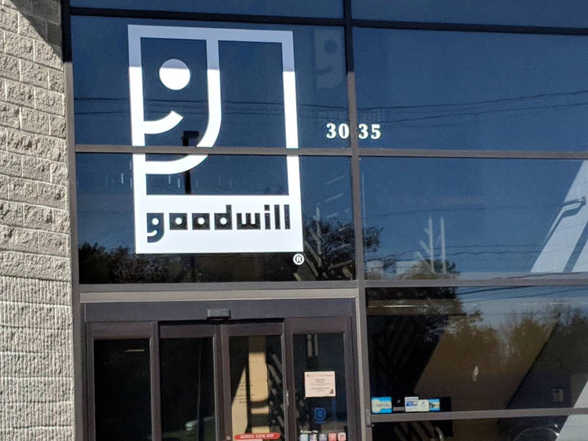 Goodwill Outlet Center in Grandville, Michigan, showing blue rolling bins filled with discounted merchandise.